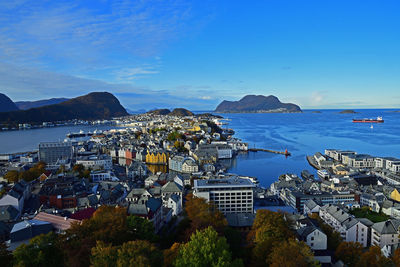 High angle view of city by sea against sky