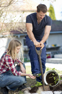 Young couple working in garden, stockholm, sweden