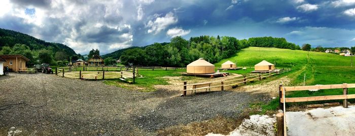 Panoramic view of houses and trees against sky