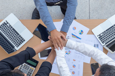 High angle view of people working on table