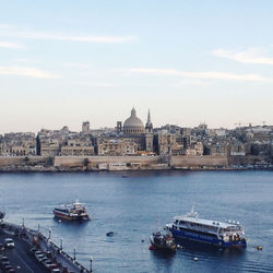 Boats in sea against sky