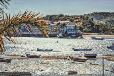 Boats moored in sea against sky