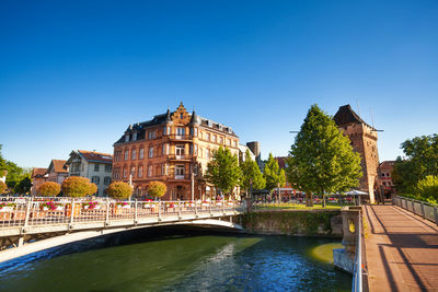 Arch bridge over river against buildings