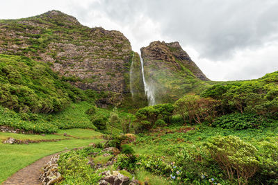 Scenic view of waterfall against sky