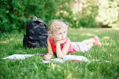 Full length of boy lying on grassy field