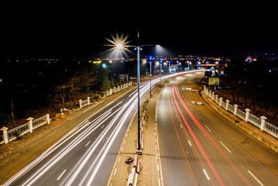 High angle view of light trails on highway at night