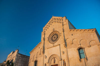 Low angle view of building against clear blue sky