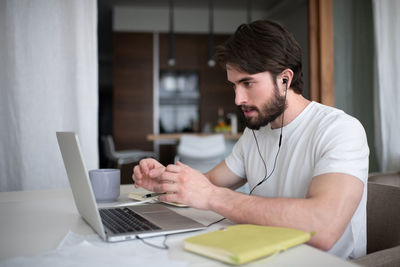 Bearded man making video call to colleagues