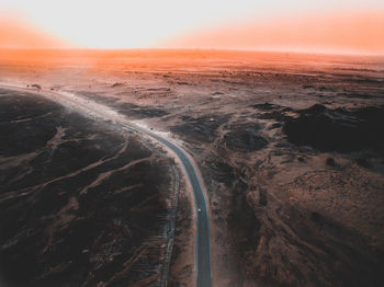 Aerial view of road against sky during sunset