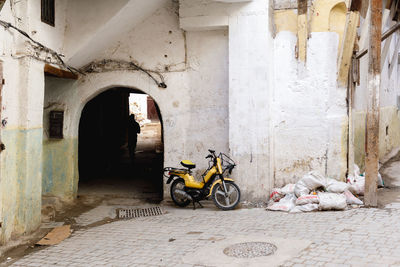 Motorcycle parked on street against building in city