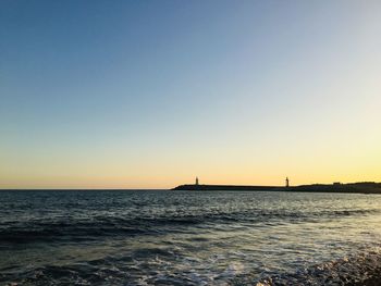 Scenic view of sea against clear sky during sunset