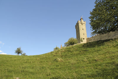 Low angle view of castle against blue sky