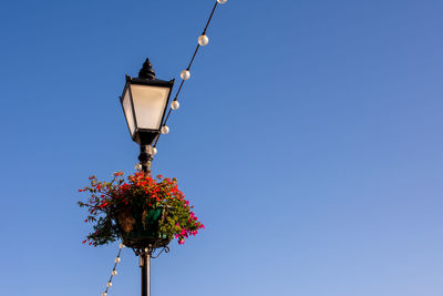 Low angle view of street light against clear blue sky