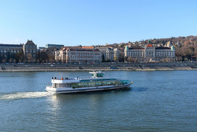 Boats in sea against clear sky