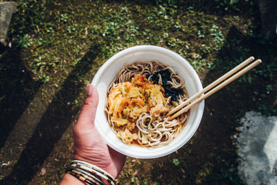 Directly above of eating soba noodles in the yard in japan / personal perspective