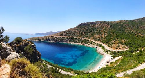 Scenic view of bay against clear blue sky