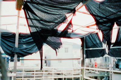 Low section of man standing by railing