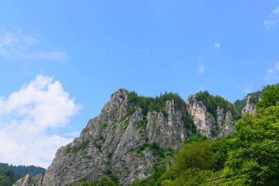 Low angle view of rock formation against sky