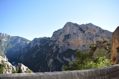 Scenic view of mountains against clear blue sky