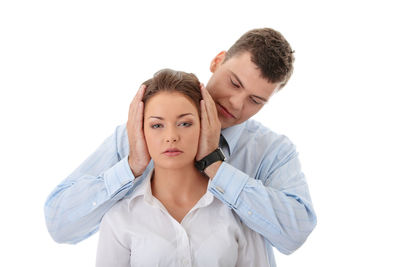 Portrait of a smiling young woman over white background