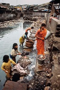 People working in river at market