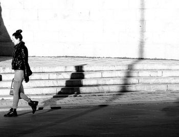 Full length of woman walking on street in city