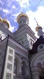 Low angle view of building against cloudy sky