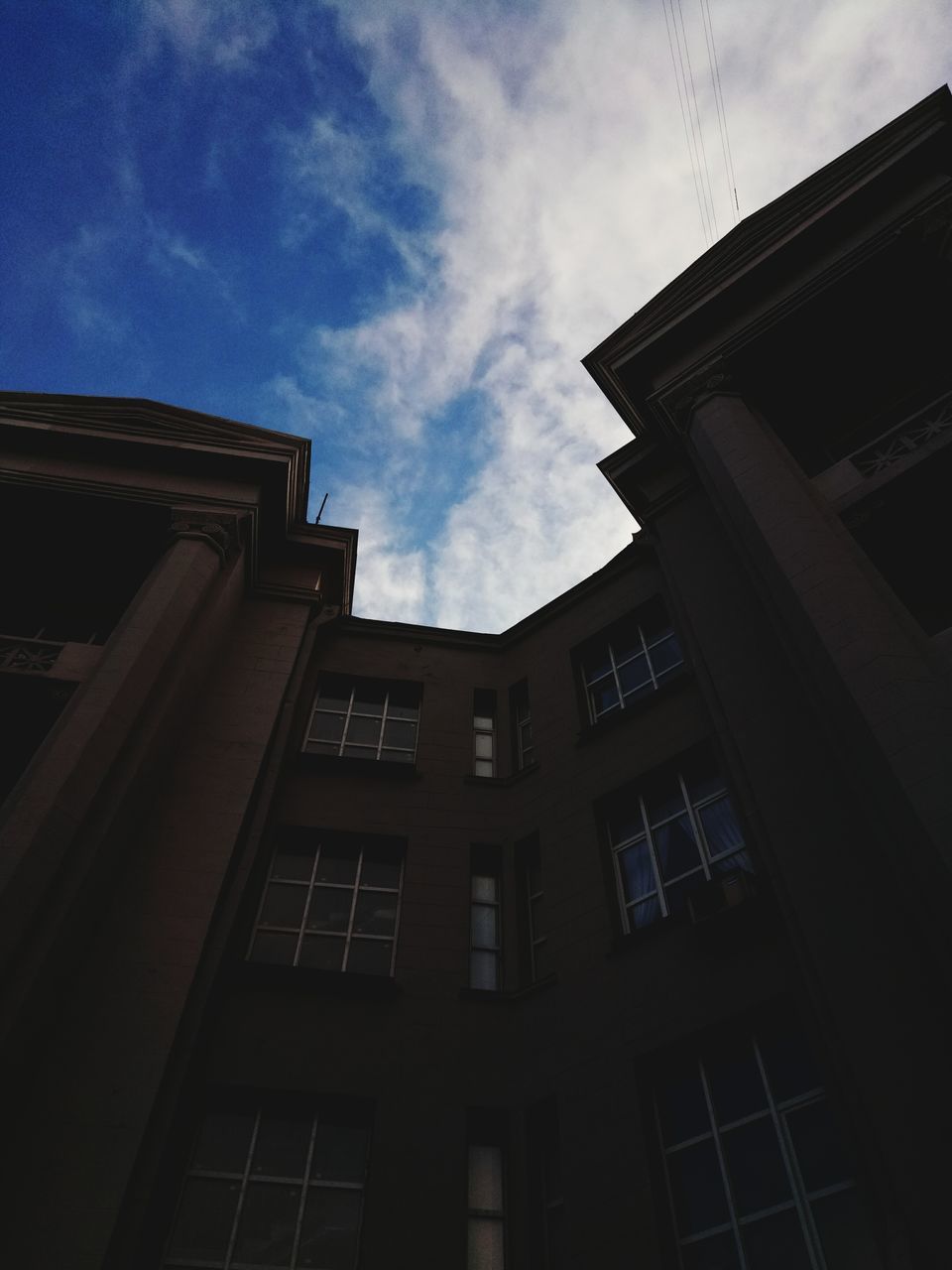 building exterior, architecture, low angle view, built structure, sky, window, no people, city, outdoors, cloud - sky, day