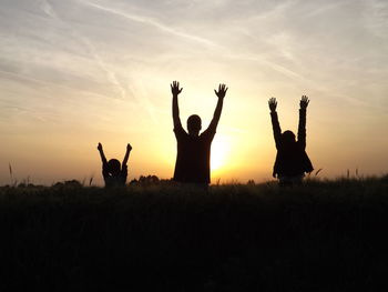 People on field at sunset