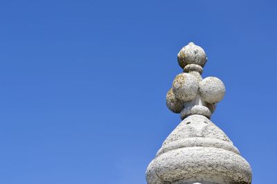 Low angle view of statue against clear blue sky