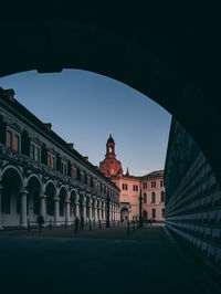 Buildings in town against clear sky