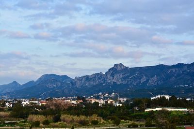 Town by sea against sky