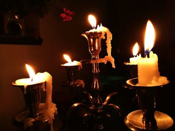 Close-up of candles burning at night