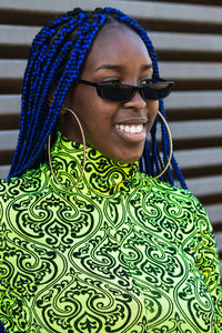 Portrait of smiling young woman wearing sunglasses