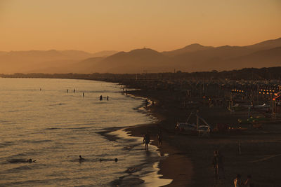 Scenic view of beach against sky during sunset