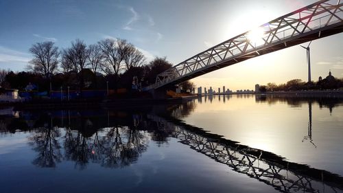 Bridge over river with buildings in background