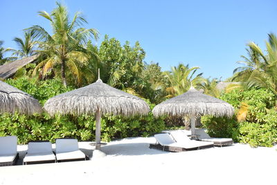 Built structure on beach against clear blue sky