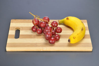 Close-up of fruits on wooden cupboard