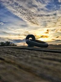 Close-up of stone wall against sky during sunset