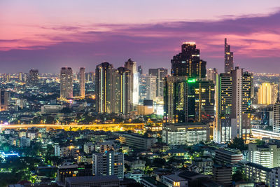 Aerial view of city lit up at night