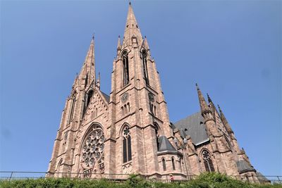 Low angle view of traditional building against clear blue sky