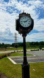 Clock tower against cloudy sky