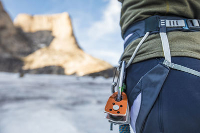 Detail view of climber harness with pulleys clipped on.