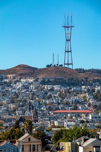 High angle view of buildings in city against clear blue sky