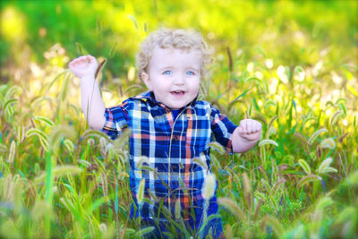 Portrait of girl standing on grassy field