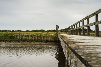 Surface level of bridge over canal against sky