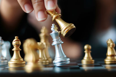 Close-up of businesswoman playing with chess at desk