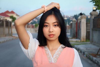 Portrait of beautiful young woman standing outdoors