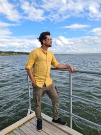 Facing wind, sea and sky - man pose on deck