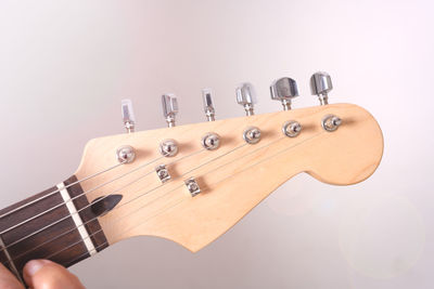 Close-up of guitar against white background